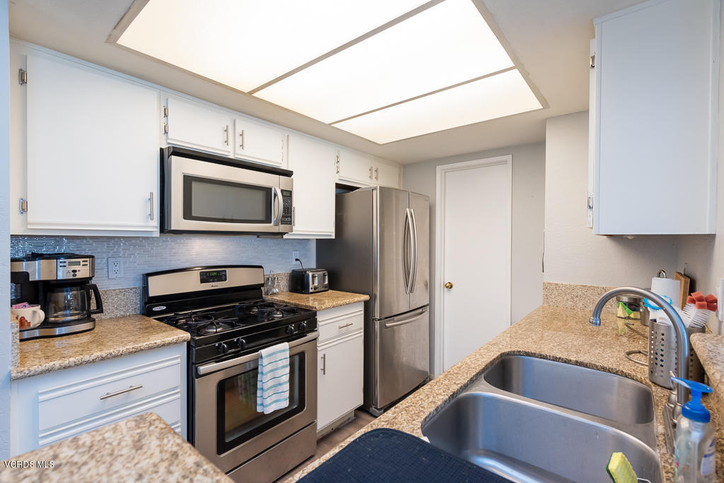 1135 Fitzgerald Road, Unit A Simi Valley, CA 93065 - Photo 16 of 49 a kitchen with stainless steel appliances a stove microwave and a sink