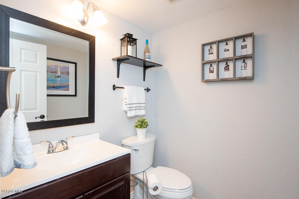 1135 Fitzgerald Road, Unit A Simi Valley, CA 93065 - Photo 19 of 49 a bathroom with a sink mirror vanity and toilet