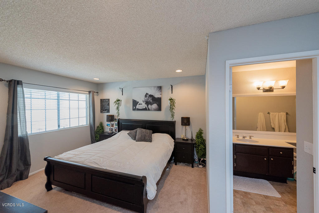 1135 Fitzgerald Road, Unit A Simi Valley, CA 93065 - Photo 23 of 49 a bed sitting in a spacious bedroom next to a window