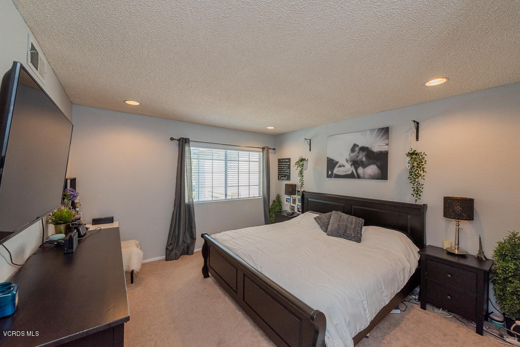 1135 Fitzgerald Road, Unit A Simi Valley, CA 93065 - Photo 24 of 49 a bedroom with a bed and a flat screen tv
