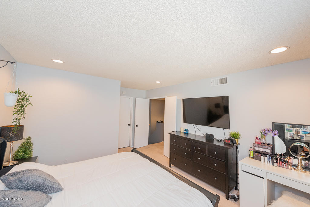 1135 Fitzgerald Road, Unit A Simi Valley, CA 93065 - Photo 26 of 49 a bedroom with a bed and a flat screen tv