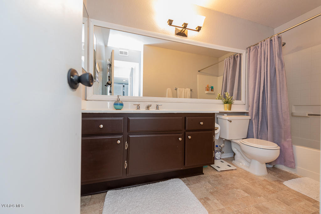 1135 Fitzgerald Road, Unit A Simi Valley, CA 93065 - Photo 28 of 49 a bathroom with a sink vanity mirror and toilet