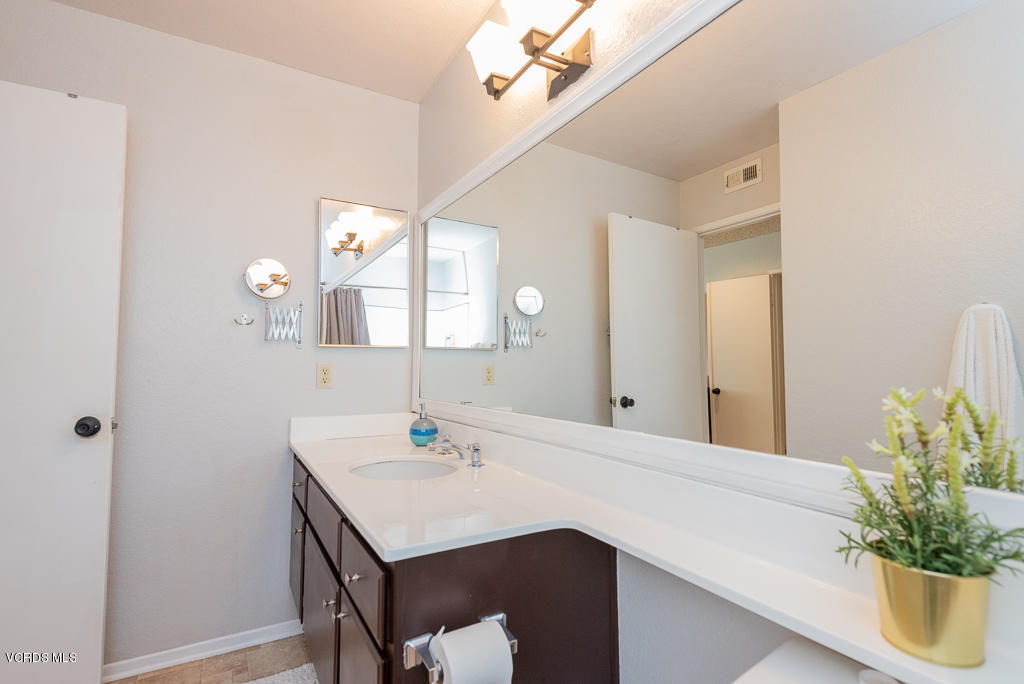1135 Fitzgerald Road, Unit A Simi Valley, CA 93065 - Photo 30 of 49 a bathroom with a sink a vanity and a mirror