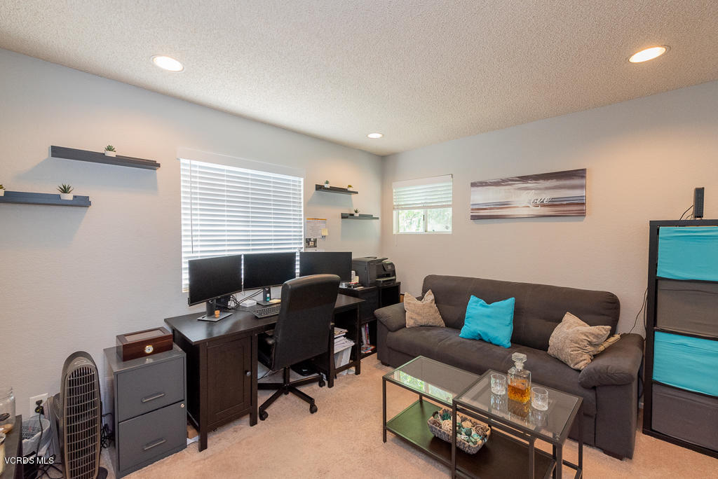 1135 Fitzgerald Road, Unit A Simi Valley, CA 93065 - Photo 33 of 49 a livingroom with workspace couch and a window