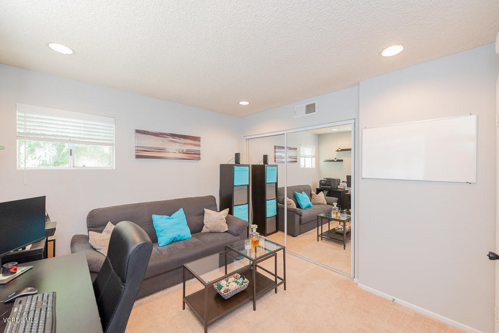 1135 Fitzgerald Road, Unit A Simi Valley, CA 93065 - Photo 34 of 49 a living room with furniture and a flat screen tv