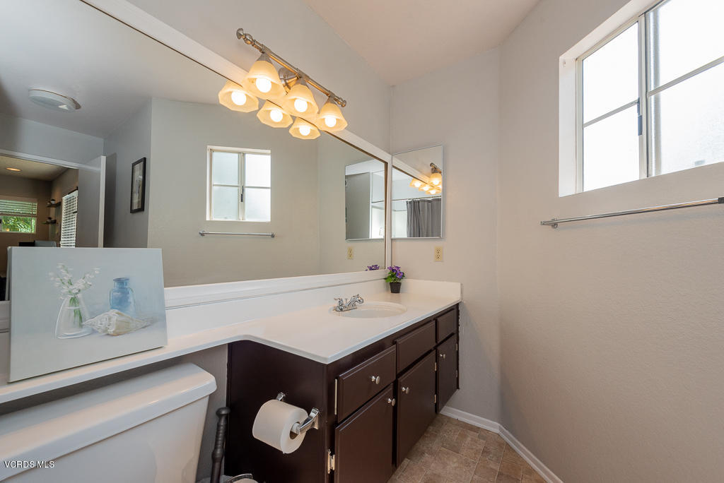 1135 Fitzgerald Road, Unit A Simi Valley, CA 93065 - Photo 36 of 49 a bathroom with a sink a vanity and a mirror