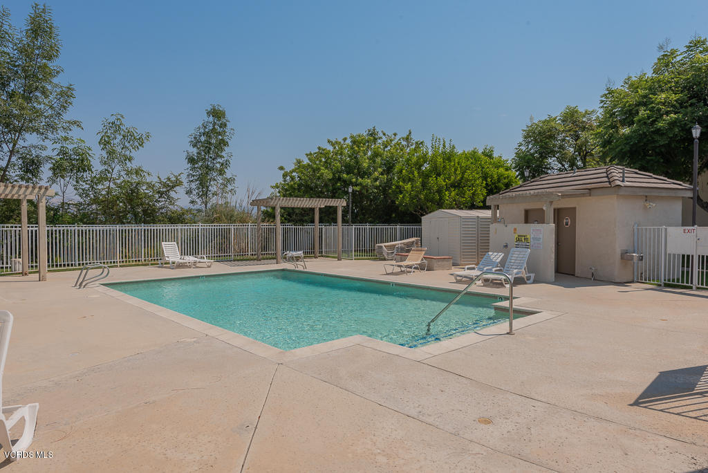 1135 Fitzgerald Road, Unit A Simi Valley, CA 93065 - Photo 44 of 49 a view of a patio with table and chairs under an umbrella