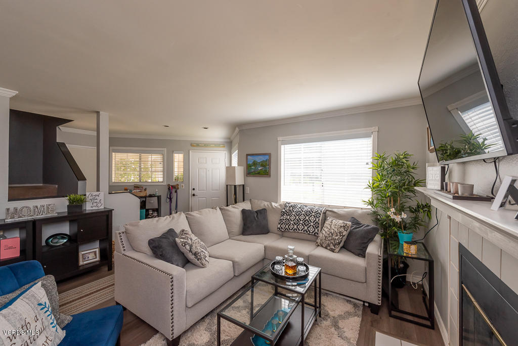 1135 Fitzgerald Road, Unit A Simi Valley, CA 93065 - Photo 6 of 49 a living room with furniture a large window and a fireplace