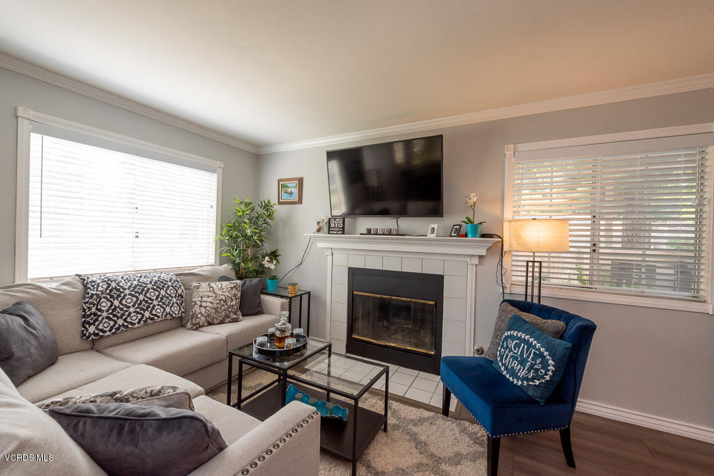 1135 Fitzgerald Road, Unit A Simi Valley, CA 93065 - Photo 7 of 49 a living room with furniture a flat screen tv and a fireplace