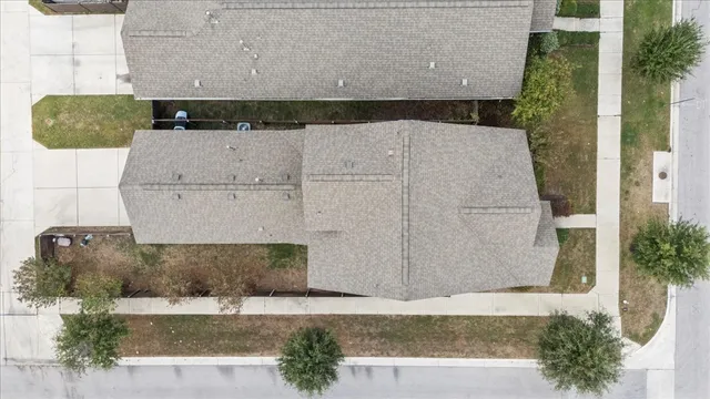 an aerial view of a house with a yard