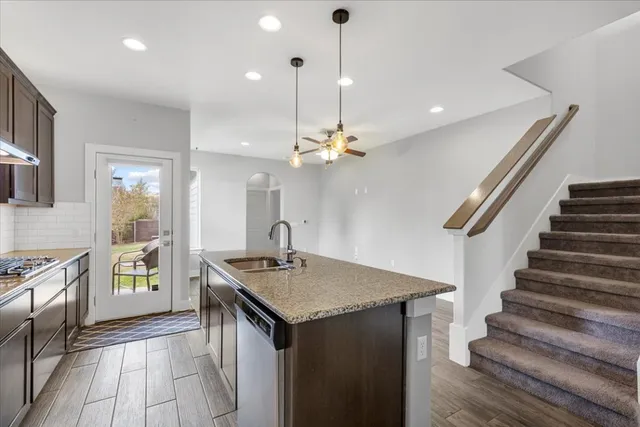 a kitchen with sink and refrigerator