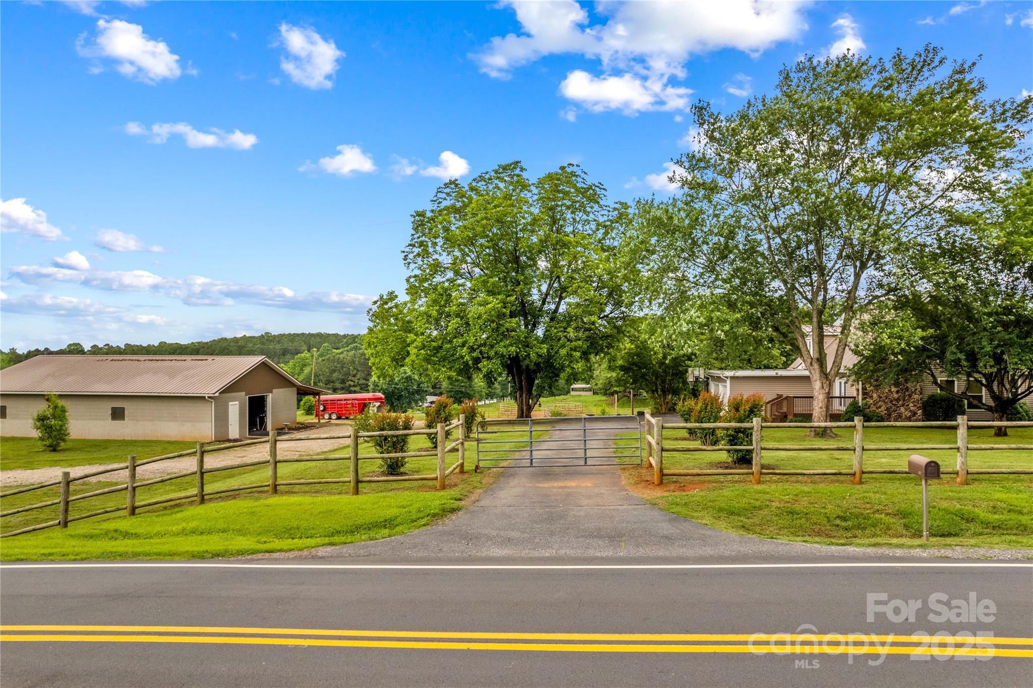 296 Hicks Creek Road Troutman, NC 28166 - Photo 7 of 48 a view of a big yard with palm trees