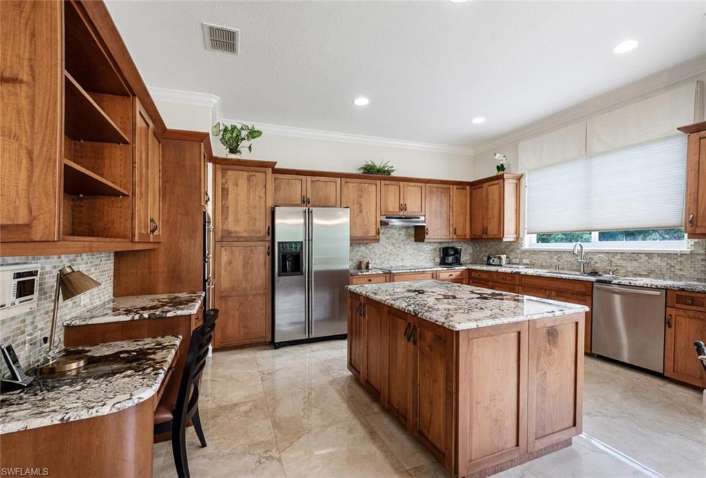 3019 Lancaster Drive, Unit 3 Naples, FL 34105 - Photo 11 of 35 a kitchen with stainless steel appliances granite countertop a stove refrigerator sink and dishwasher