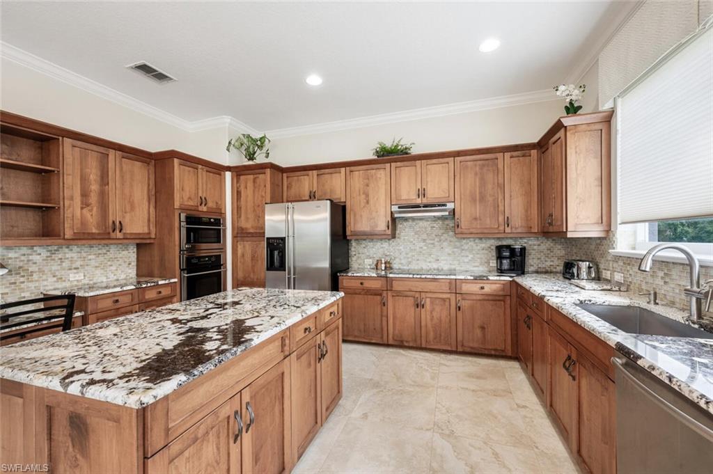 3019 Lancaster Drive, Unit 3 Naples, FL 34105 - Photo 12 of 35 a kitchen with stainless steel appliances granite countertop a sink stove and refrigerator