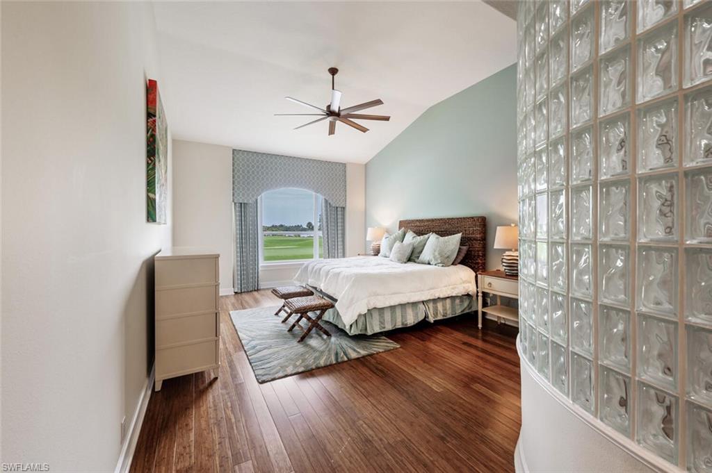 3019 Lancaster Drive, Unit 3 Naples, FL 34105 - Photo 21 of 35 a bedroom with a bed lamps and wooden floor