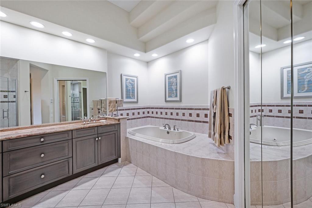 3019 Lancaster Drive, Unit 3 Naples, FL 34105 - Photo 23 of 35 a bathroom with a tub sink and mirror