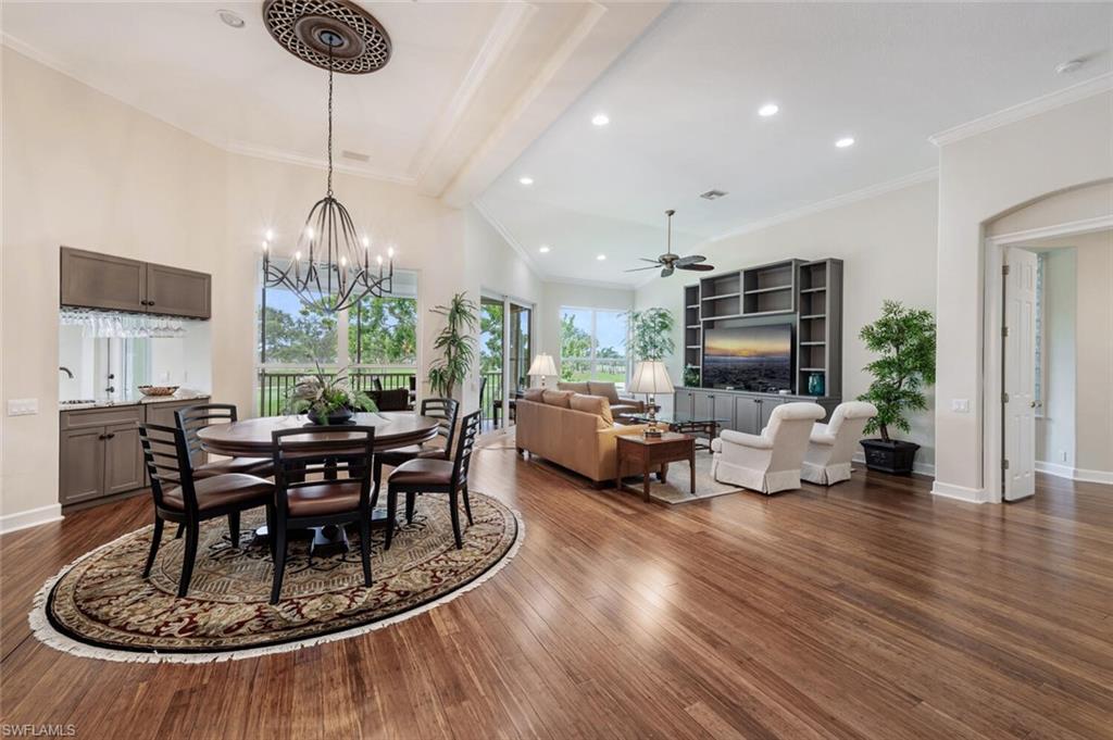 3019 Lancaster Drive, Unit 3 Naples, FL 34105 - Photo 4 of 35 a dining room with furniture a chandelier and wooden floor