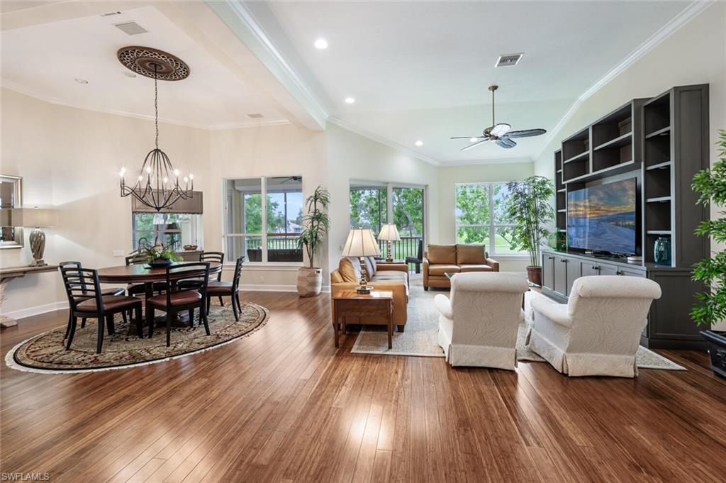 3019 Lancaster Drive, Unit 3 Naples, FL 34105 - Photo 5 of 35 a living room with furniture a dining table and a chandelier