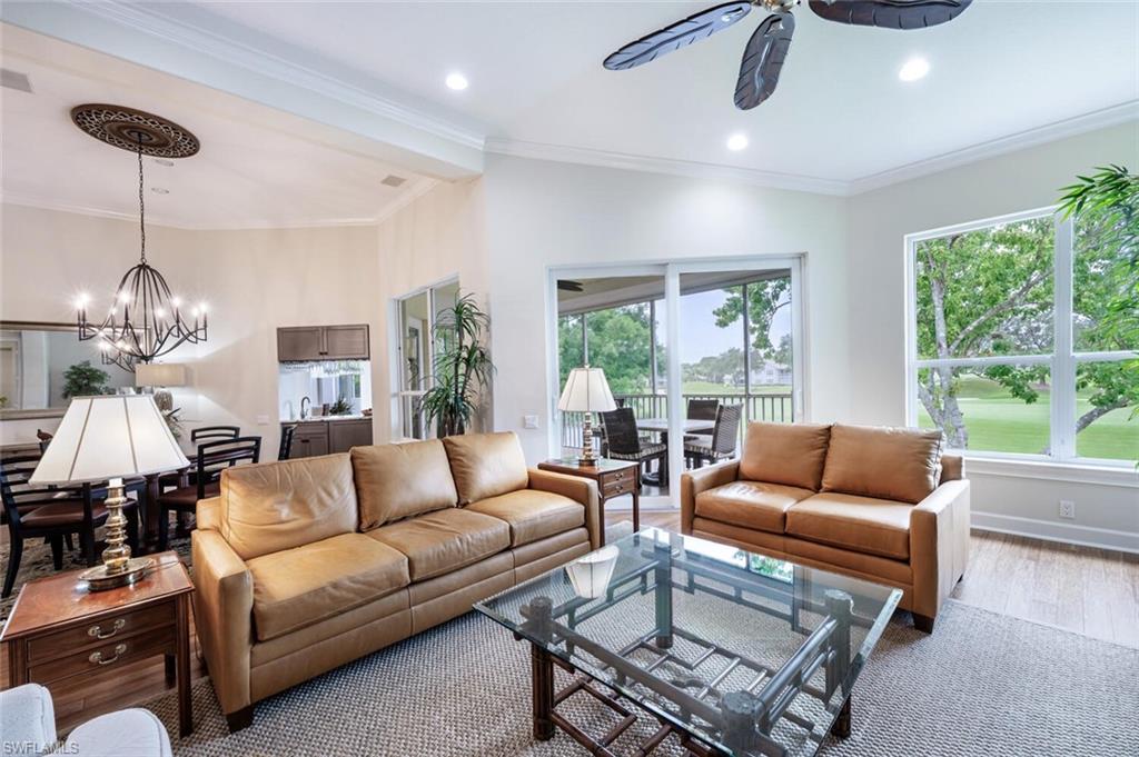 3019 Lancaster Drive, Unit 3 Naples, FL 34105 - Photo 7 of 35 a living room with furniture and a chandelier