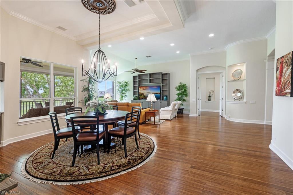 3019 Lancaster Drive, Unit 3 Naples, FL 34105 - Photo 9 of 35 a view of a dining room with furniture wooden floor and chandelier
