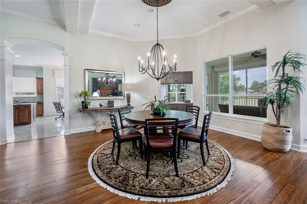 3019 Lancaster Drive, Unit 3 Naples, FL 34105 - Photo 10 of 35 a view of a dining room with furniture a chandelier and wooden floor