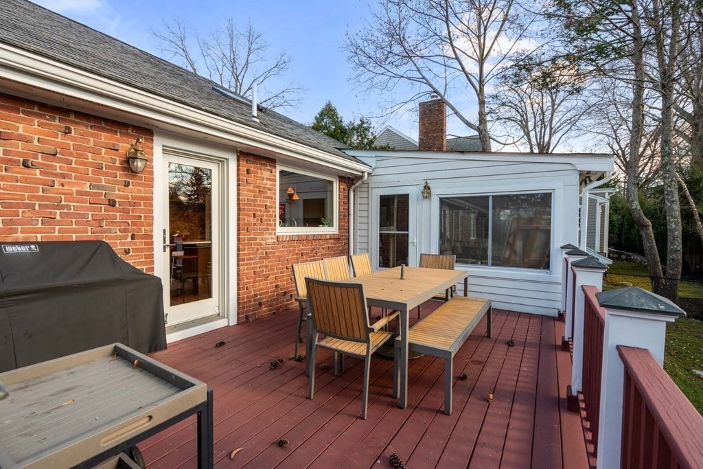 52 Sherbrooke Road Newton, MA 02458 - Photo 31 of 35 a view of a patio with table and chairs with wooden floor and fence