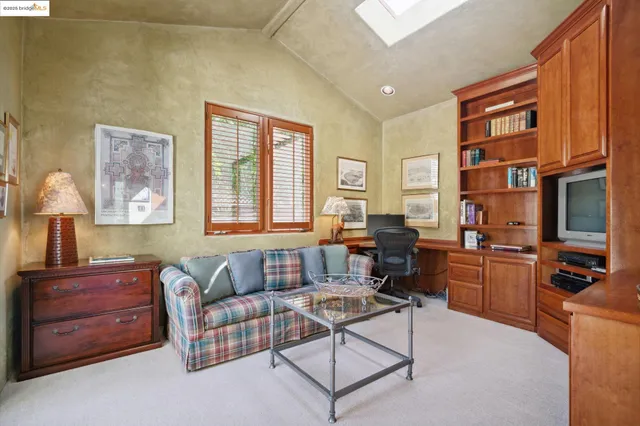 a living room with furniture a flat screen tv and a window
