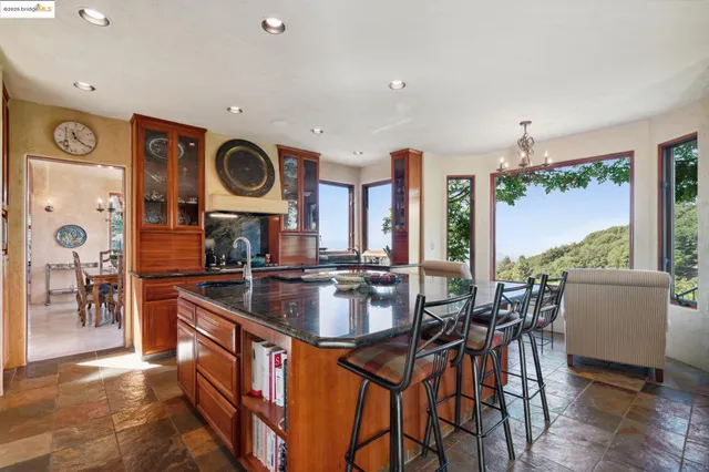 a kitchen with stainless steel appliances granite countertop a stove and cabinets