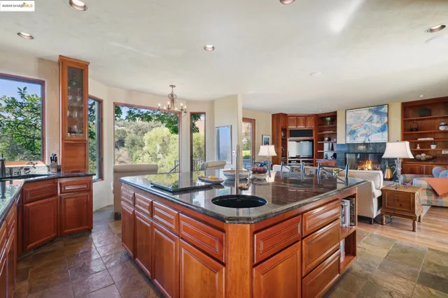 a kitchen with stainless steel appliances granite countertop a sink and a counter