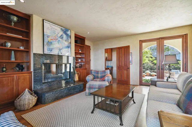 a living room with furniture and a floor to ceiling window
