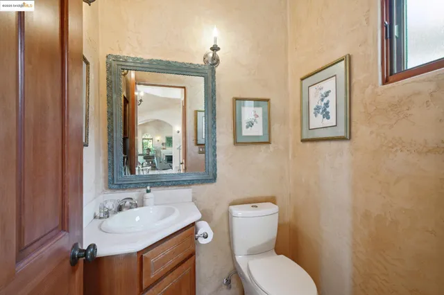 a bathroom with a toilet a sink and mirror