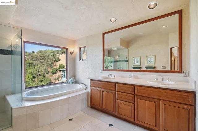 a bathroom with a tub sink and mirror