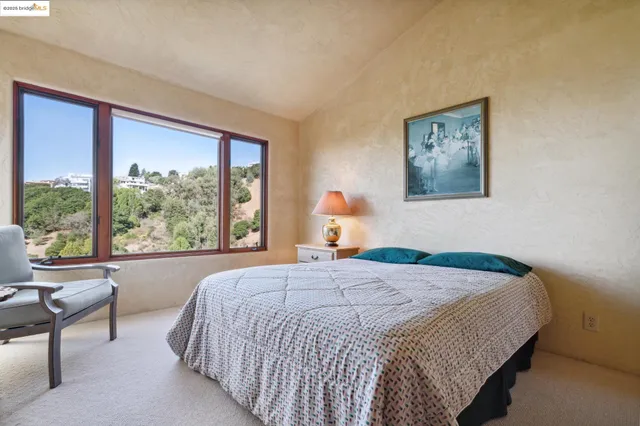 a bedroom with a bed and a large window