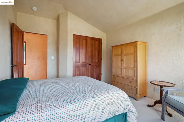 a bedroom with a bed and a table in it