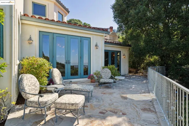 a view of a chairs and table in backyard of the house