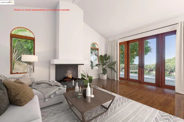 a living room with furniture fireplace and a large window