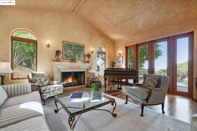 a living room with furniture fireplace and a large window