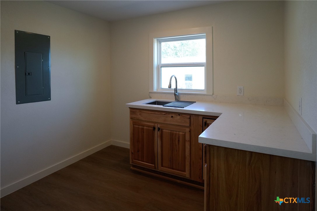5688 Falke-Heinrich Road Schulenburg, TX 78956 - Photo 11 of 34 a kitchen with a sink a window and cabinets