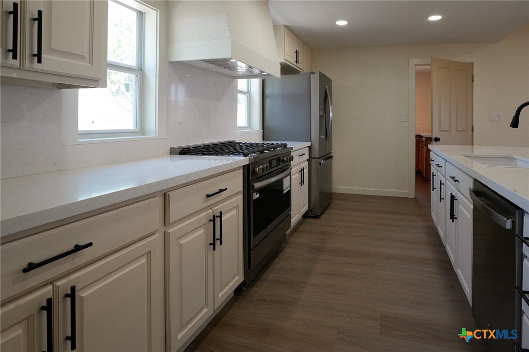 5688 Falke-Heinrich Road Schulenburg, TX 78956 - Photo 15 of 34 a large kitchen with stainless steel appliances granite countertop a stove a sink and a refrigerator