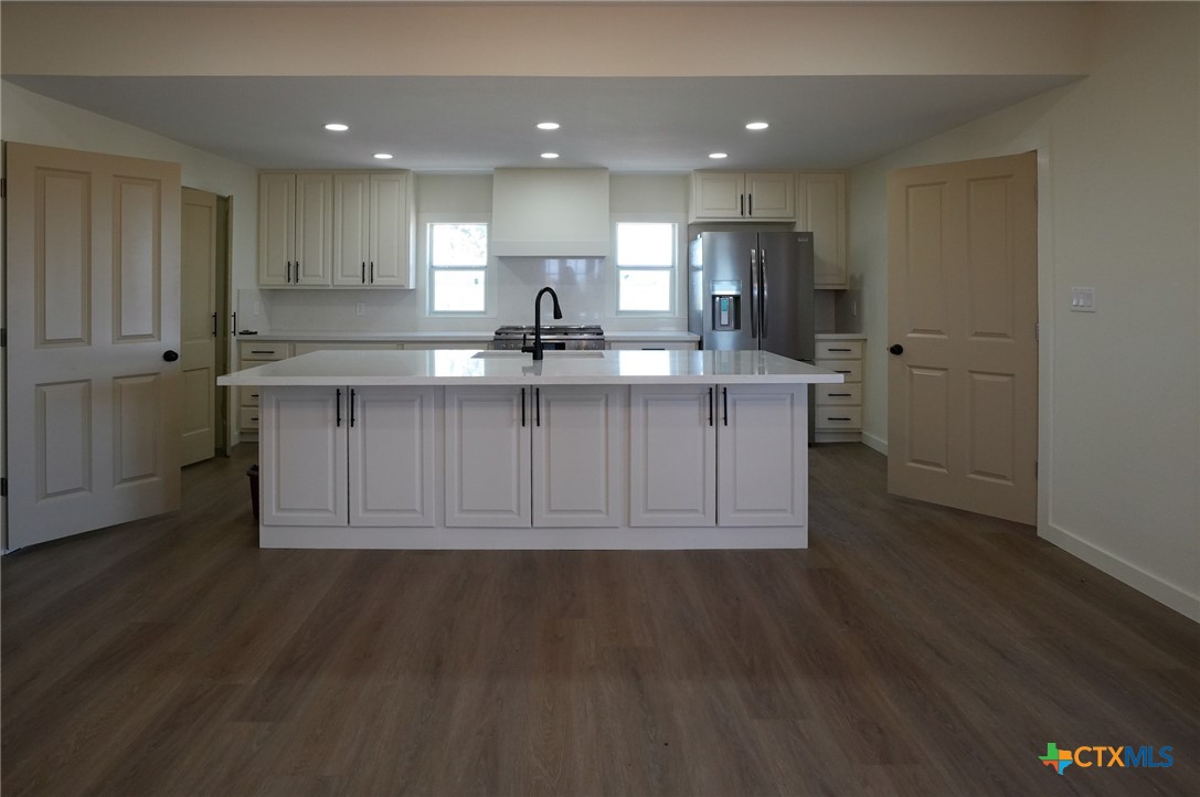 5688 Falke-Heinrich Road Schulenburg, TX 78956 - Photo 16 of 34 a kitchen with stainless steel appliances granite countertop a sink a stove a refrigerator and cabinets