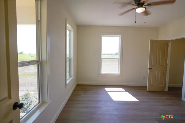 a view of hallway with wooden floor