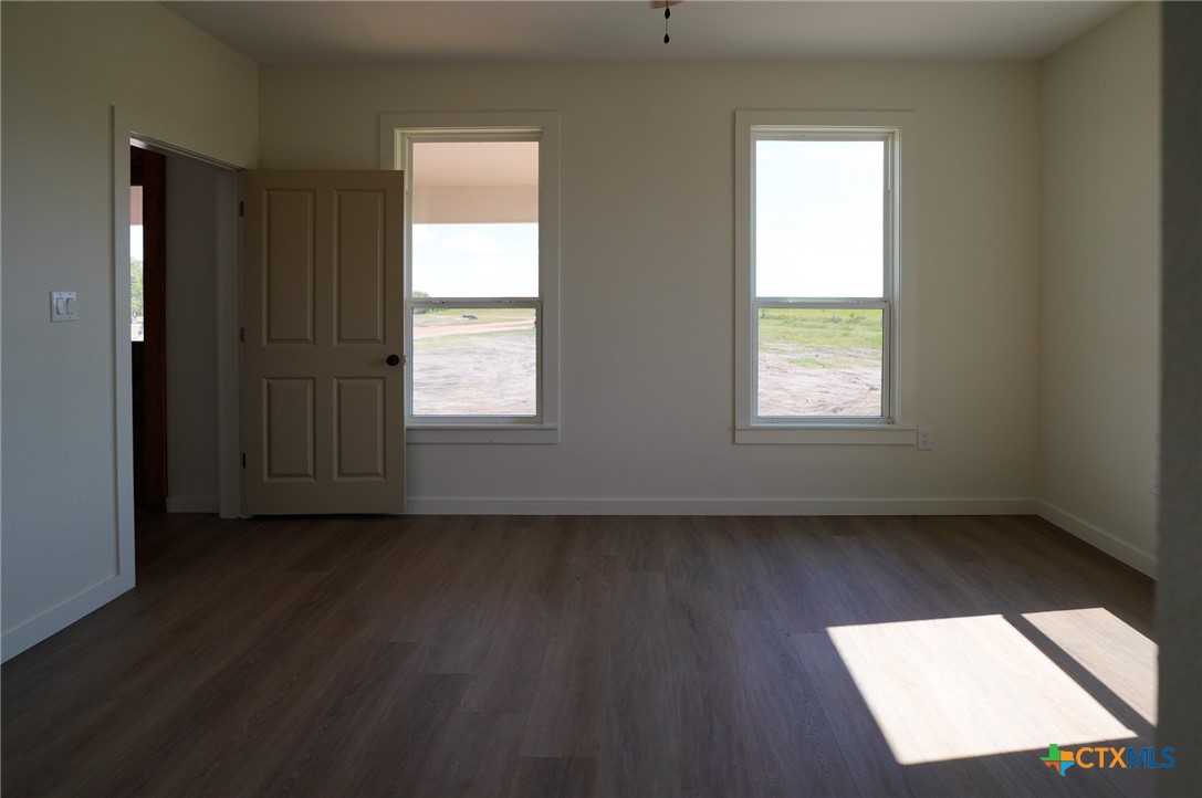 5688 Falke-Heinrich Road Schulenburg, TX 78956 - Photo 20 of 34 an empty room with wooden floor and windows