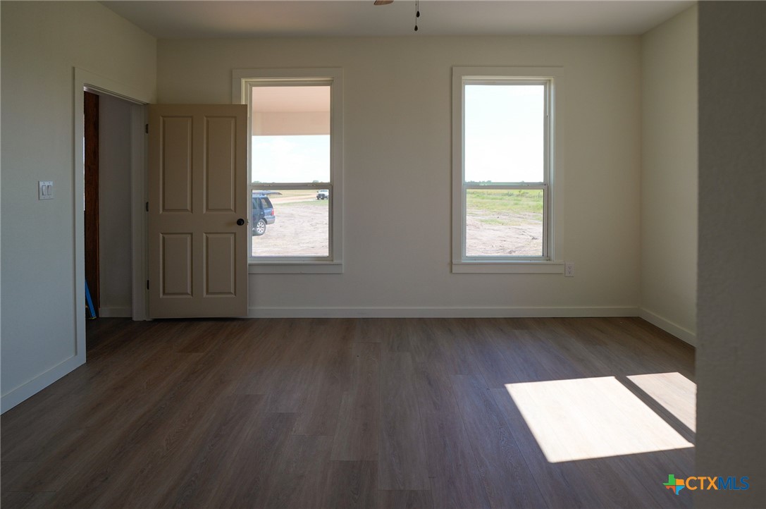 5688 Falke-Heinrich Road Schulenburg, TX 78956 - Photo 27 of 34 an empty room with wooden floor and windows