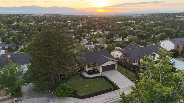 8760 Rustler Road Cottonwood Heights, UT 84093 - Photo 55 of 57 Ranch-style residence featuring a dark asphalt shingle roof, attached garage, and a concrete driveway
