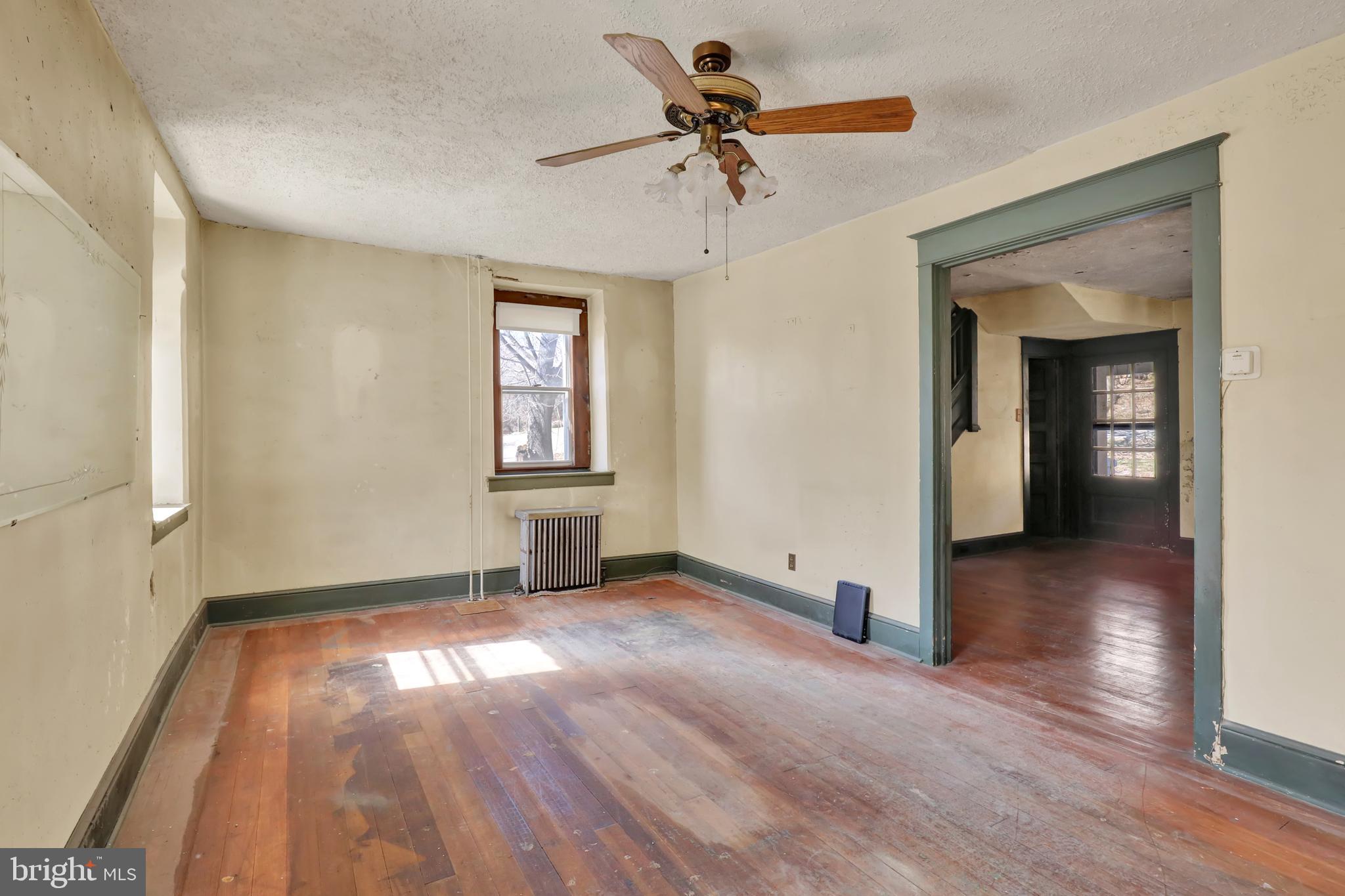 1250 New Philadelphia Road Pottstown, PA 19465 - Photo 7 of 30 wooden floor in an empty room with a window