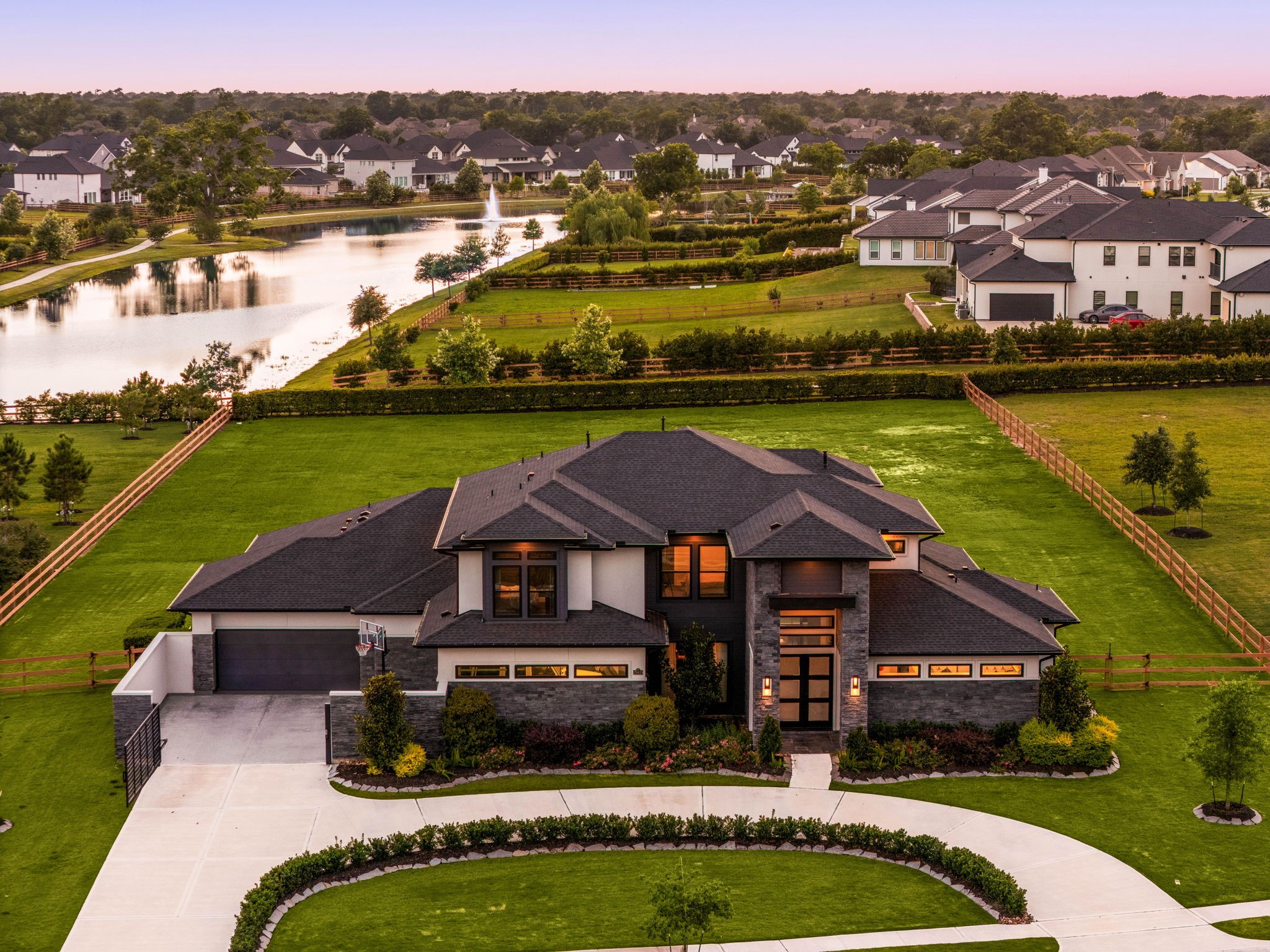 29419 Cir S Rnch Trail Fulshear, TX 77406 - Photo 37 of 45 This twilight front elevation view emphasizes the custom contemporary design, automated gate parking, and upscale architecture. Tour this home and explore all it has to offer.