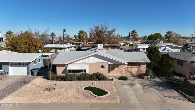 a aerial view of a house with a yard and garage