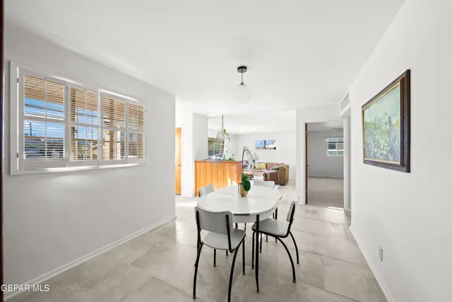 a view of a dining room with furniture and window