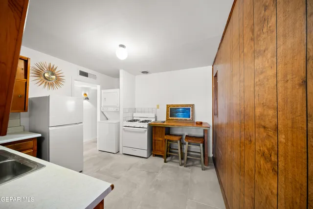 a room with furniture a sink and a refrigerator