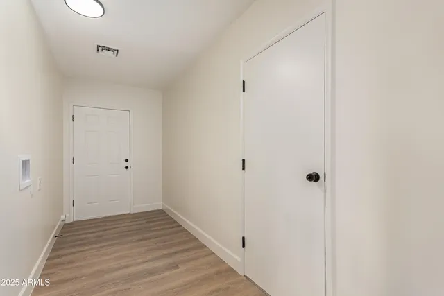 a view of a hallway with wooden floor